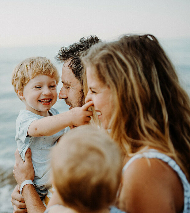 A young family with two children spend time together and enjoy their family life